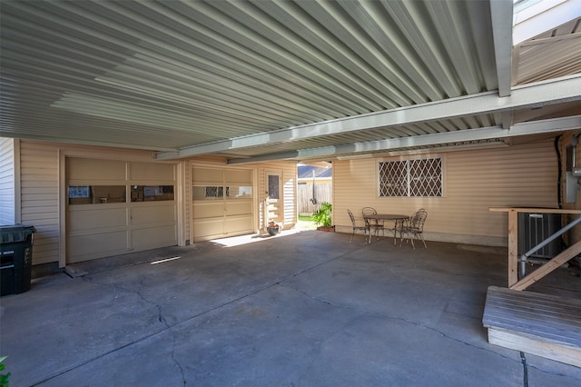 garage with central AC unit and a carport