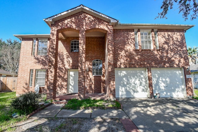 view of front facade featuring driveway, a garage, fence, and brick siding