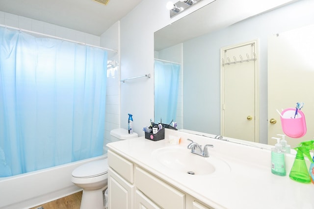 bathroom featuring toilet, wood finished floors, visible vents, vanity, and shower / bath combo