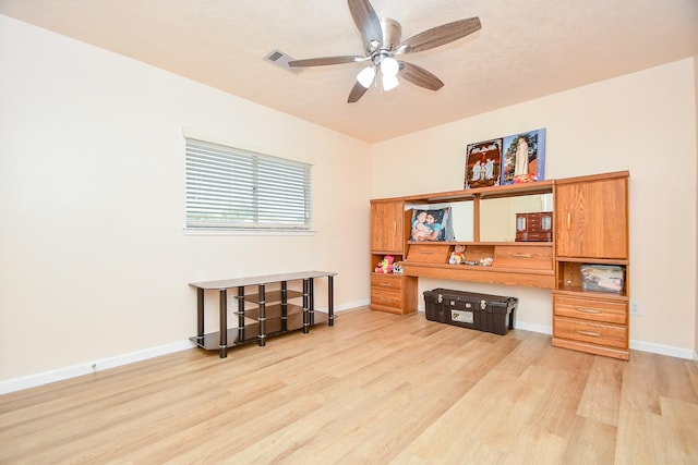 interior space featuring light wood finished floors, visible vents, baseboards, and a ceiling fan