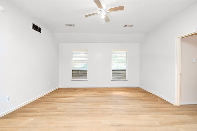 empty room featuring light wood-style flooring, visible vents, and ceiling fan