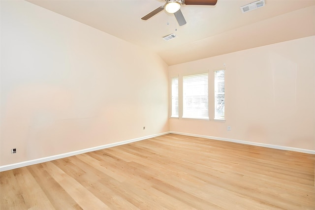 unfurnished room with light wood finished floors, baseboards, and visible vents