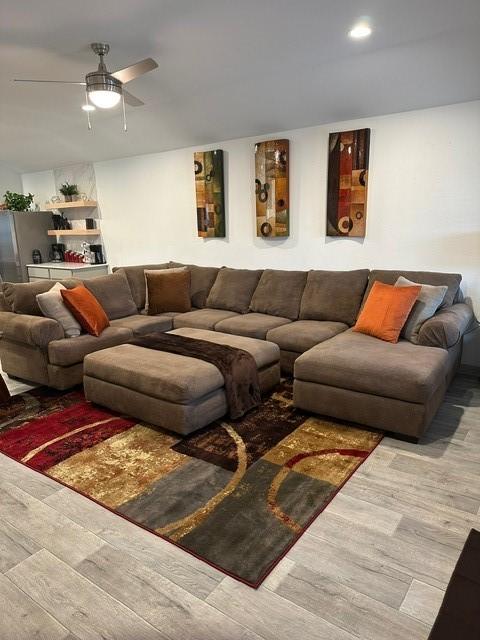 living room featuring ceiling fan, wood finished floors, and recessed lighting