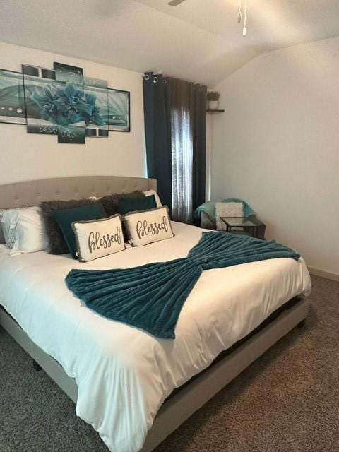 bedroom featuring vaulted ceiling and carpet flooring