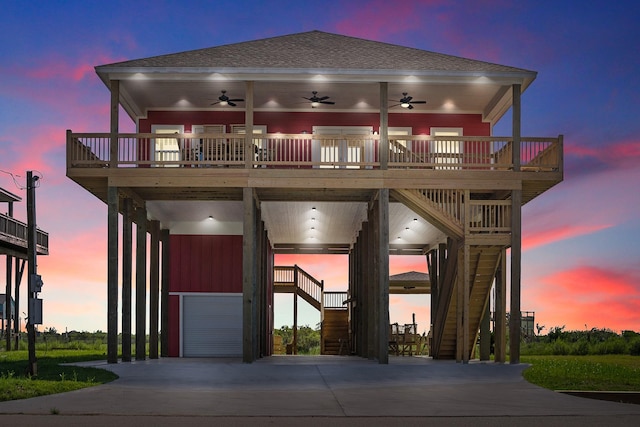 view of front facade with stairs, a deck, roof with shingles, and a ceiling fan