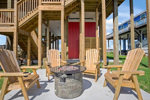 view of patio / terrace with a fire pit and stairway