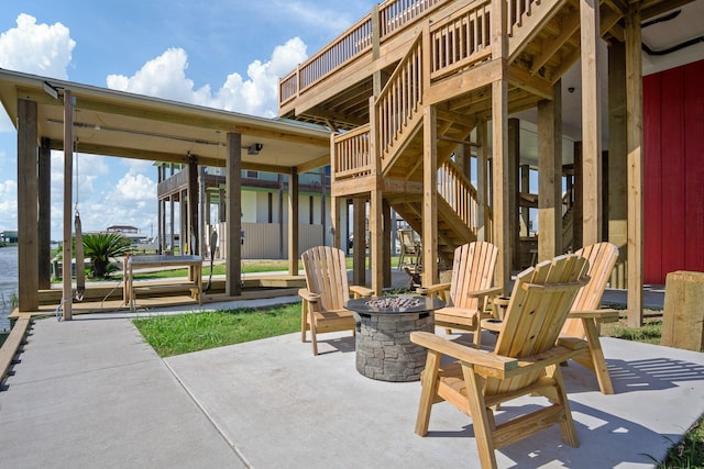 view of patio / terrace with stairs and a fire pit