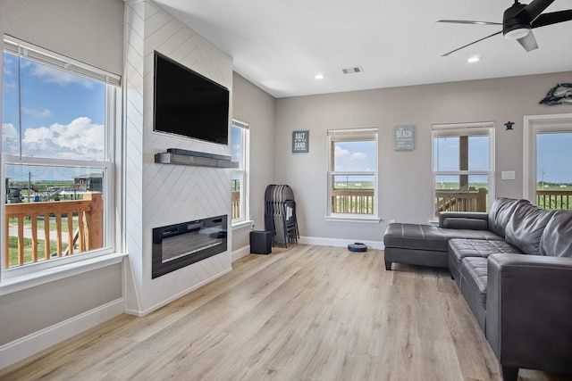 living room with a large fireplace, baseboards, a ceiling fan, wood finished floors, and recessed lighting