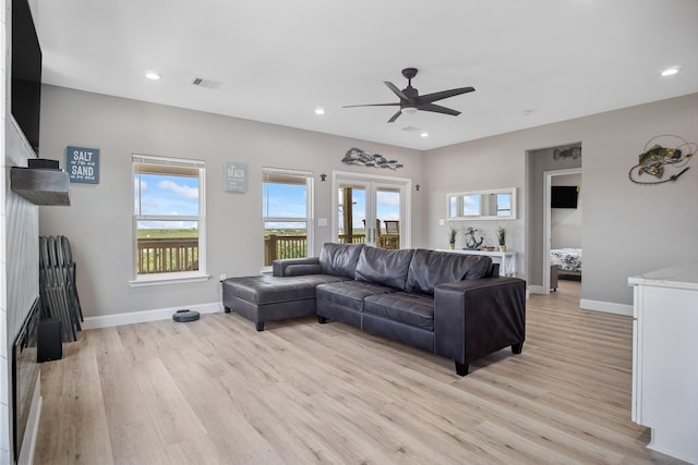 living area with light wood-style floors, visible vents, and recessed lighting