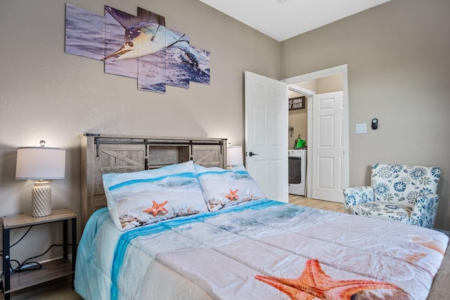 bedroom featuring washer / clothes dryer and wood finished floors