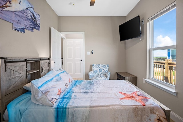 bedroom with ceiling fan and baseboards