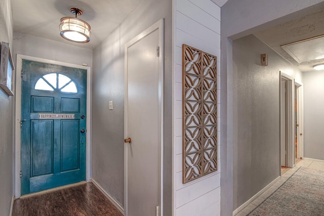 entryway with wood finished floors and baseboards