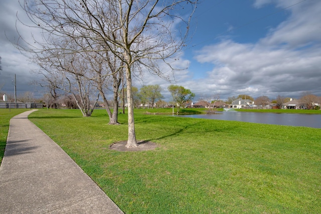 view of community featuring a lawn and a water view