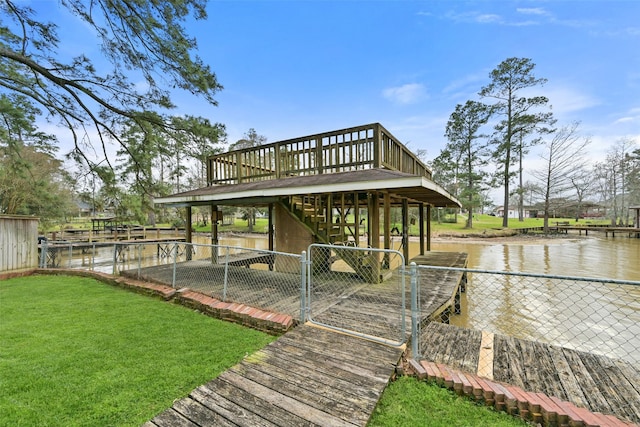 view of dock featuring fence, a lawn, and a deck with water view