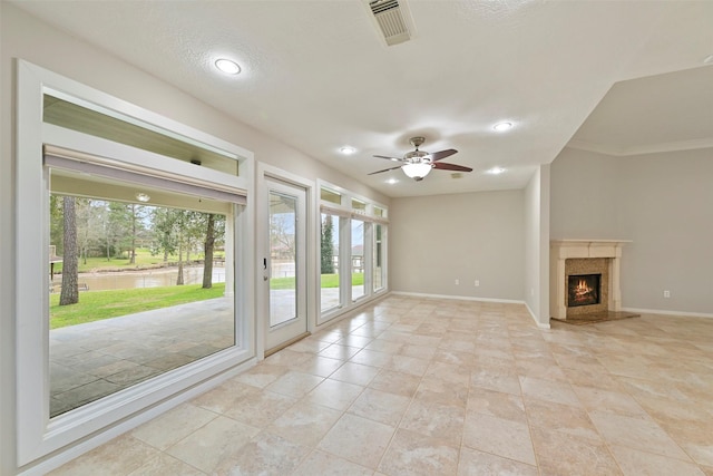 unfurnished living room with a fireplace, recessed lighting, visible vents, ceiling fan, and baseboards