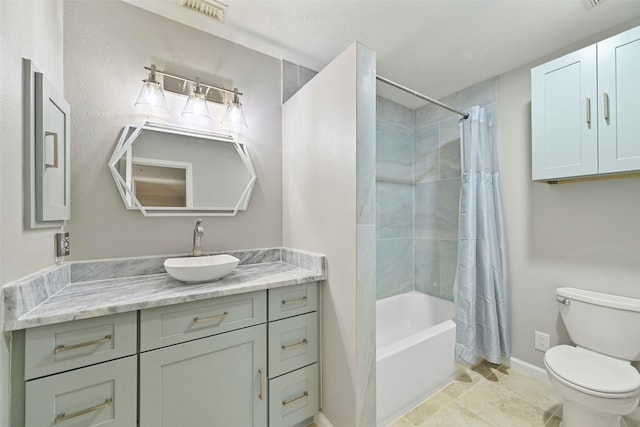 bathroom featuring shower / bath combo, visible vents, baseboards, toilet, and vanity