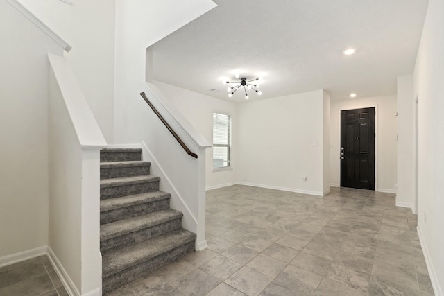 foyer with stairs, recessed lighting, and baseboards