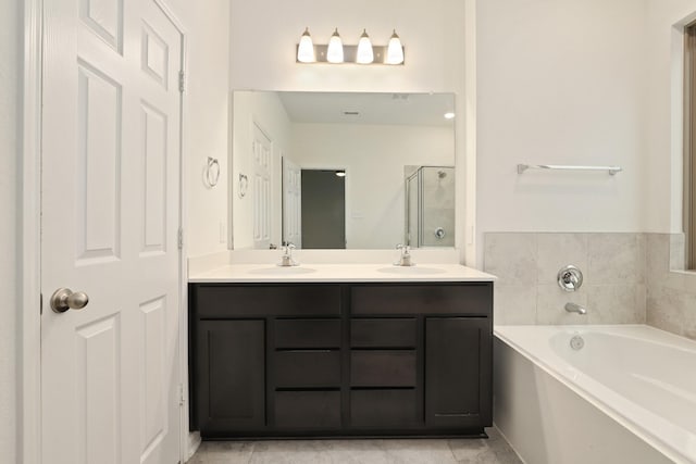 full bath featuring a garden tub, a sink, a shower stall, and double vanity