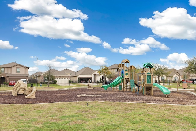 community play area with a yard, a residential view, and fence