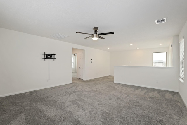 carpeted empty room with ceiling fan, recessed lighting, visible vents, and baseboards