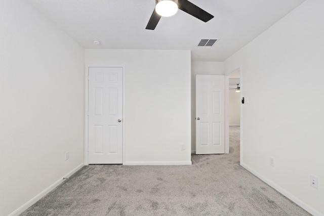 unfurnished bedroom featuring baseboards, visible vents, and carpet flooring