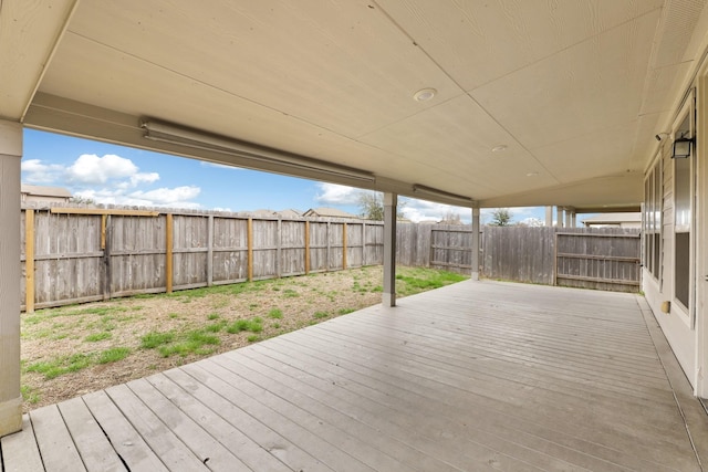 wooden deck with a fenced backyard