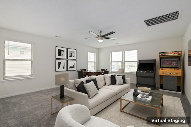 carpeted living room featuring a ceiling fan, visible vents, and baseboards