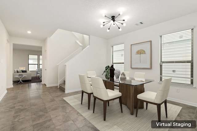 dining area featuring visible vents, stairway, a chandelier, and baseboards