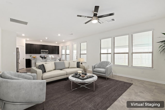 living room featuring recessed lighting, visible vents, and baseboards