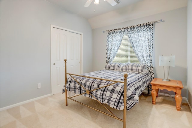 bedroom with a ceiling fan, lofted ceiling, light colored carpet, and baseboards