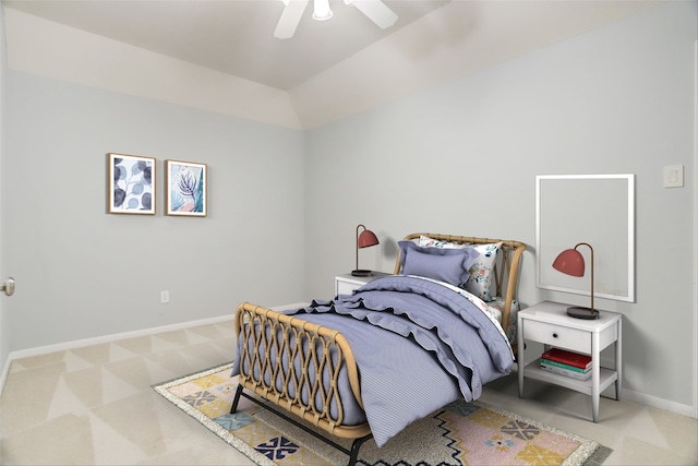 bedroom with carpet, baseboards, vaulted ceiling, and a ceiling fan