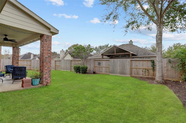 view of yard featuring a ceiling fan, a fenced backyard, and a patio