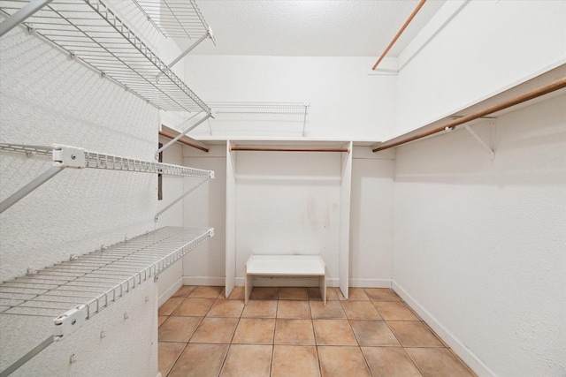 spacious closet with light tile patterned floors