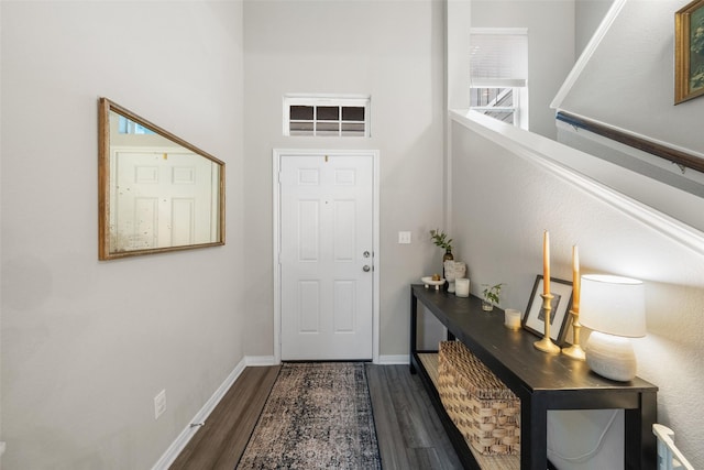 entryway featuring dark wood-style floors, stairway, and baseboards