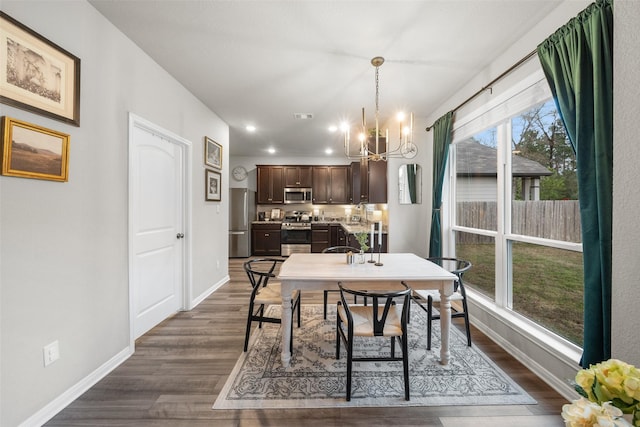 dining area with dark wood-style floors, visible vents, baseboards, recessed lighting, and a notable chandelier