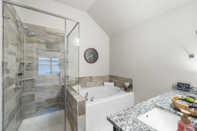 full bathroom with a garden tub, a stall shower, vanity, and lofted ceiling