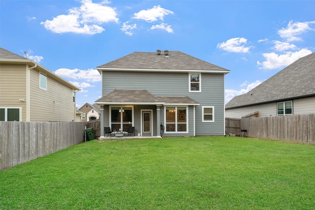 back of house with a patio, a lawn, and a fenced backyard