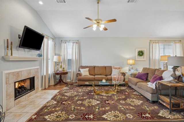 living room with a wealth of natural light, visible vents, and lofted ceiling