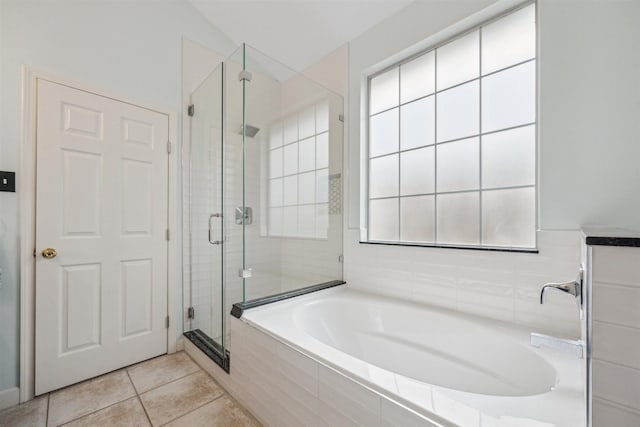 bathroom featuring tile patterned floors, a shower stall, and a garden tub