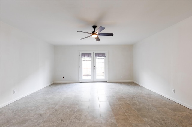 empty room with french doors, a ceiling fan, and baseboards