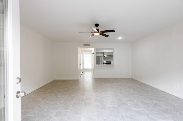 unfurnished room featuring ceiling fan, visible vents, and baseboards