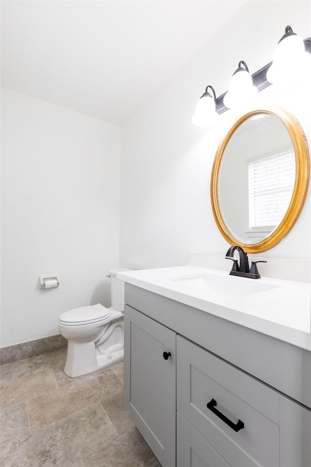 bathroom with toilet and vanity