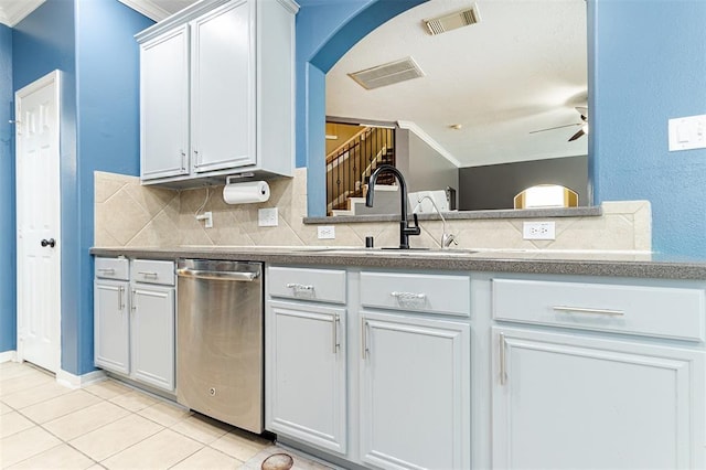 kitchen featuring a sink, visible vents, stainless steel dishwasher, decorative backsplash, and dark countertops