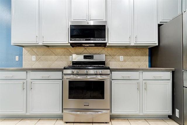 kitchen featuring white cabinetry, stainless steel appliances, and backsplash