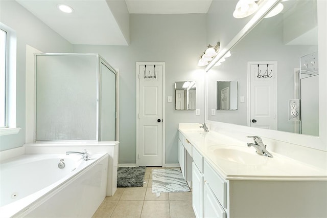 bathroom with double vanity, a sink, a shower stall, tile patterned flooring, and a bath