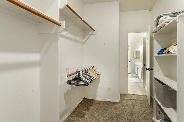 spacious closet featuring carpet flooring and tile patterned floors