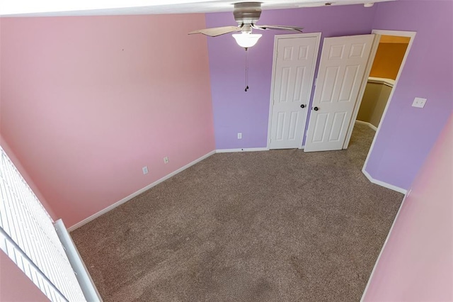 unfurnished bedroom with a closet, baseboards, and carpet flooring