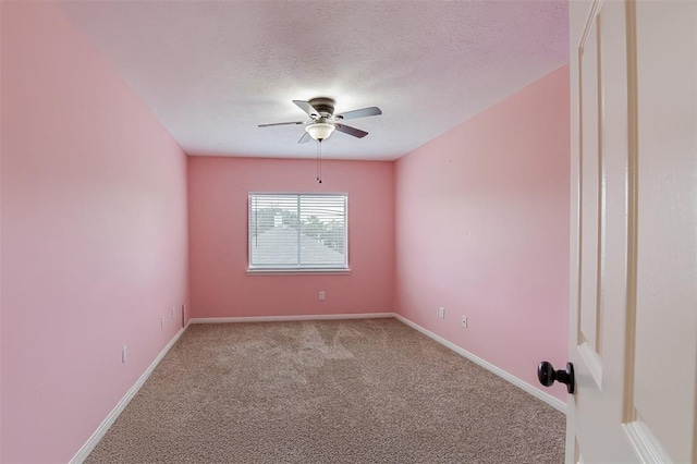 unfurnished room featuring a ceiling fan, carpet, baseboards, and a textured ceiling