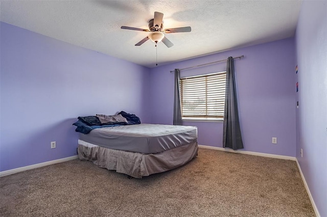 carpeted bedroom featuring ceiling fan, baseboards, and a textured ceiling