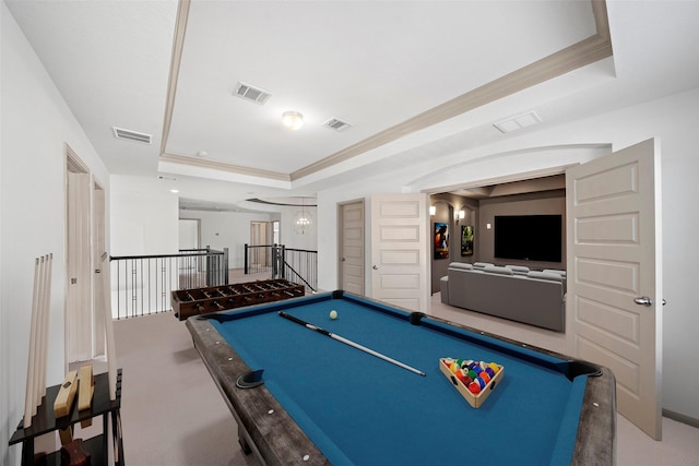 rec room with a tray ceiling, visible vents, and crown molding